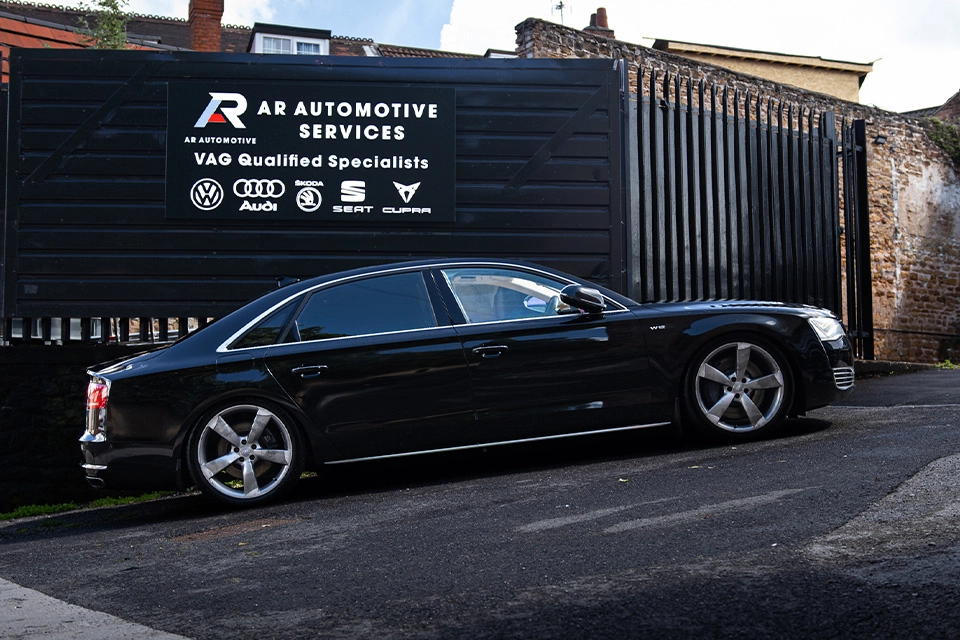 Black Audi parked in front of the AR Automotive Services signage